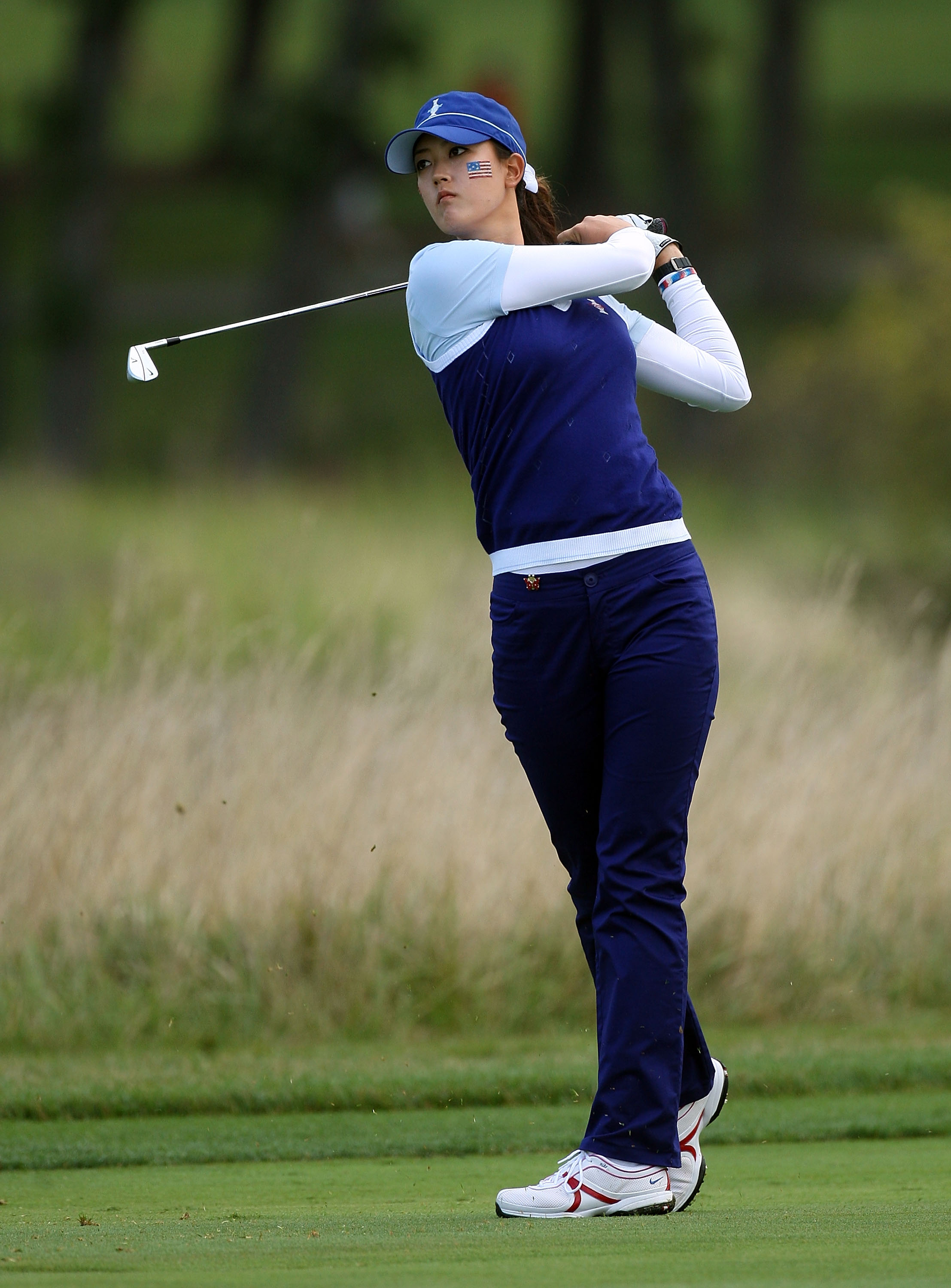 SUGAR GROVE, IL - AUGUST 21:  Michelle Wie of the U.S. Team hits her approach shot on the first hole  during the friday morning fourball matches at the 2009 Solheim Cup at Rich Harvest Farms on August 21, 2009 in Sugar Grove, Illinois.  (Photo by David Cannon/Getty Images)